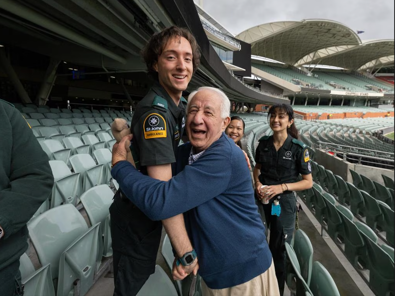 Douglas Schirripa hugging St John Ambulance volunteer Tom Abdelmalek at Adelaide Oval