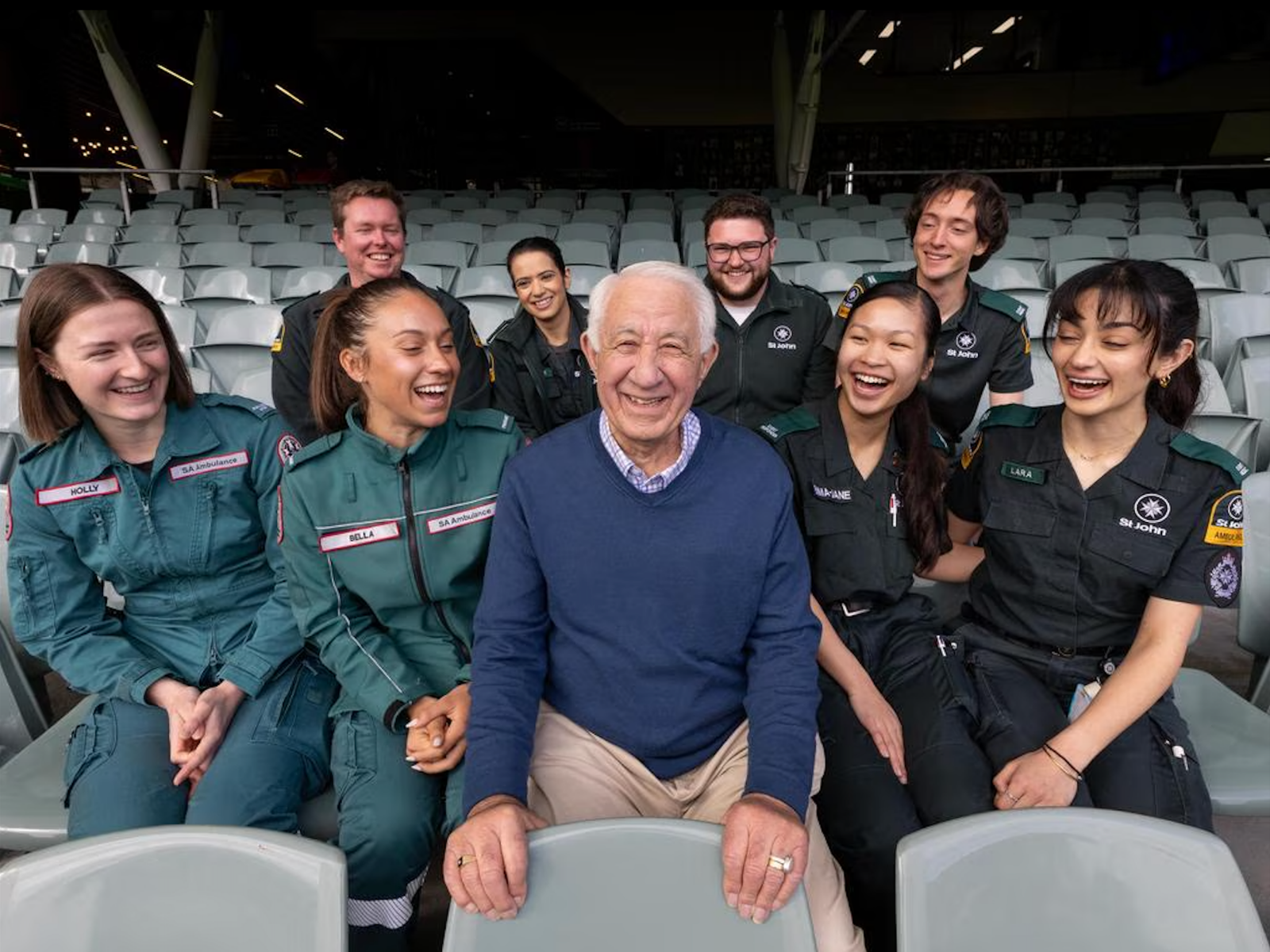 Douglas Schirripa surrounded by St John Ambulance volunteers and SA Ambulance paramedics at Adelaide Oval